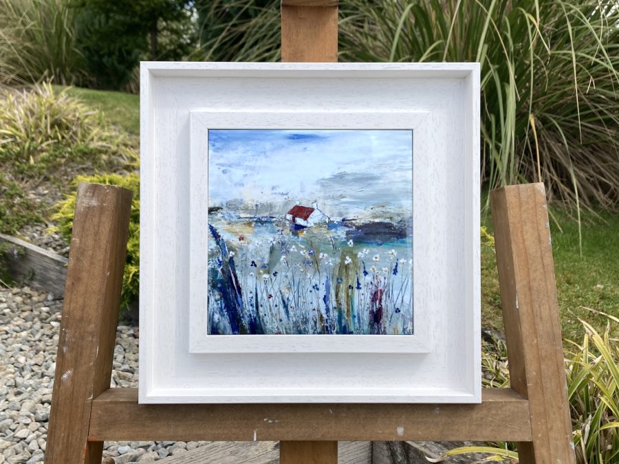 Framed ceramic tile wall art print of Scottish landscape painting featuring Highland glen and stone bothy cottage among wild flowers